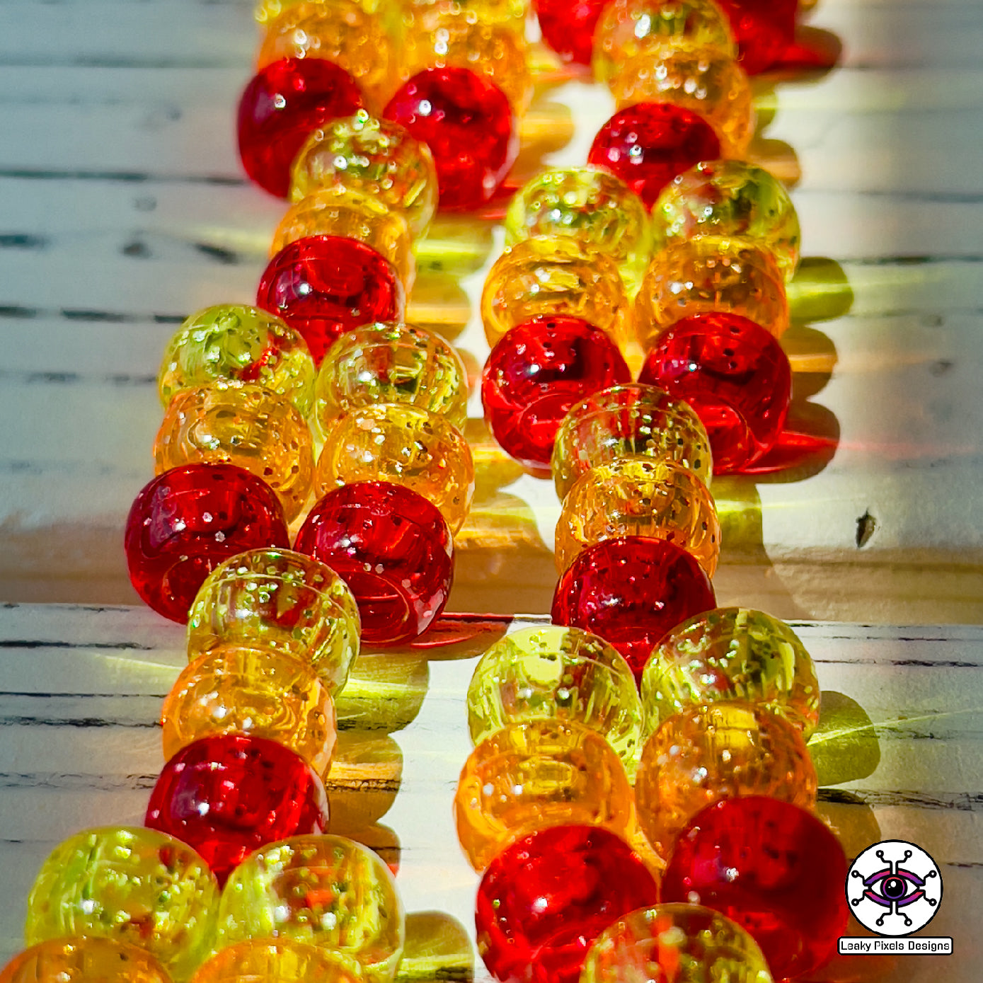 Flareon perler necklace, Orange and yellow pokemon that is dog like and fluffy. pointy ears also. necklace is made out of red, orange and yellow glitter pony beads