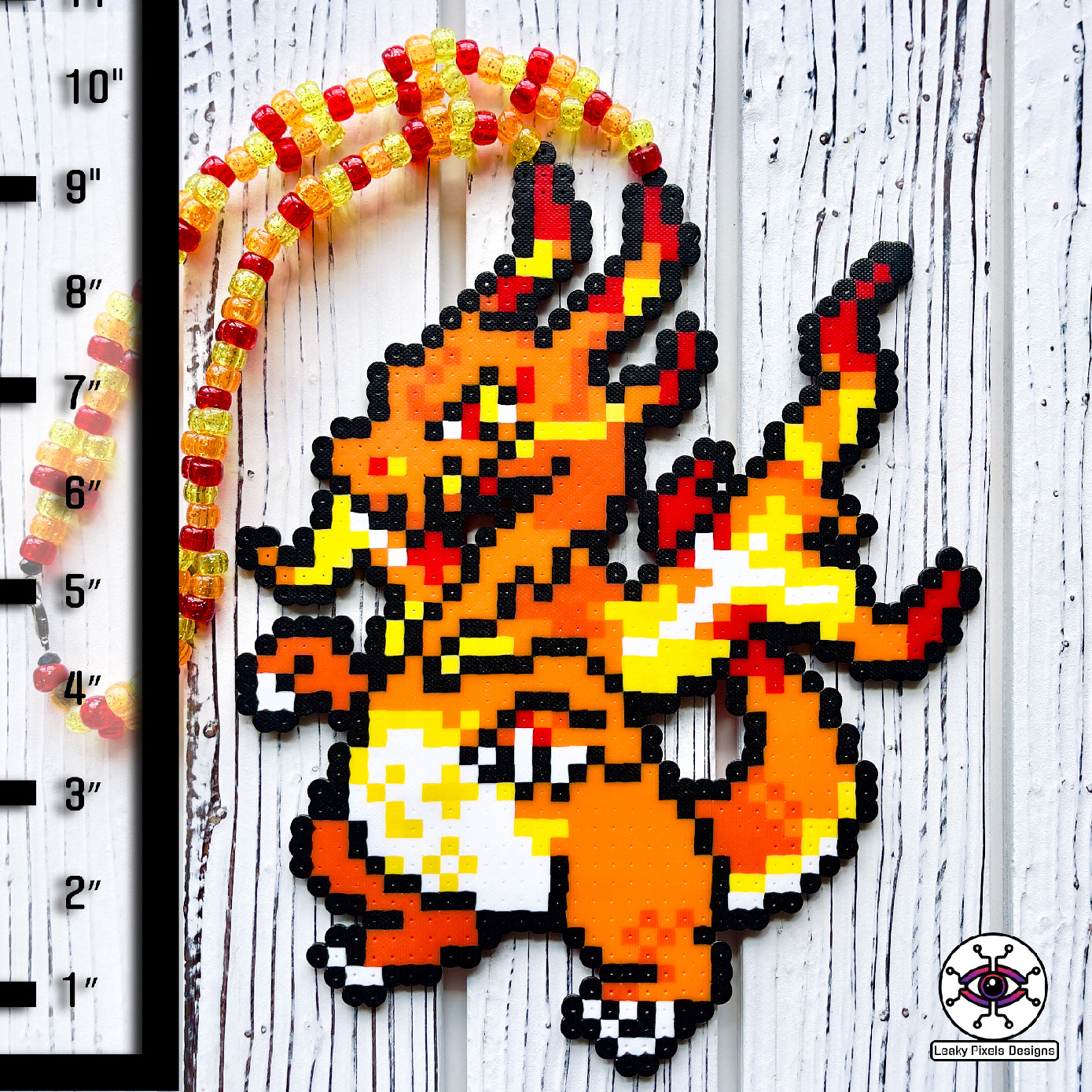 Gigantamax charizard perler necklace by leaky pixels. orange pokemon dragon with fire emitting from its body.