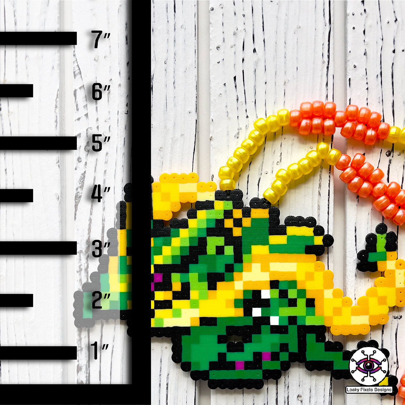 mega rayquaza pokemon perler necklace. green dragon with yellow and orange tendrils flying beside its body. pony beads make up the necklace.