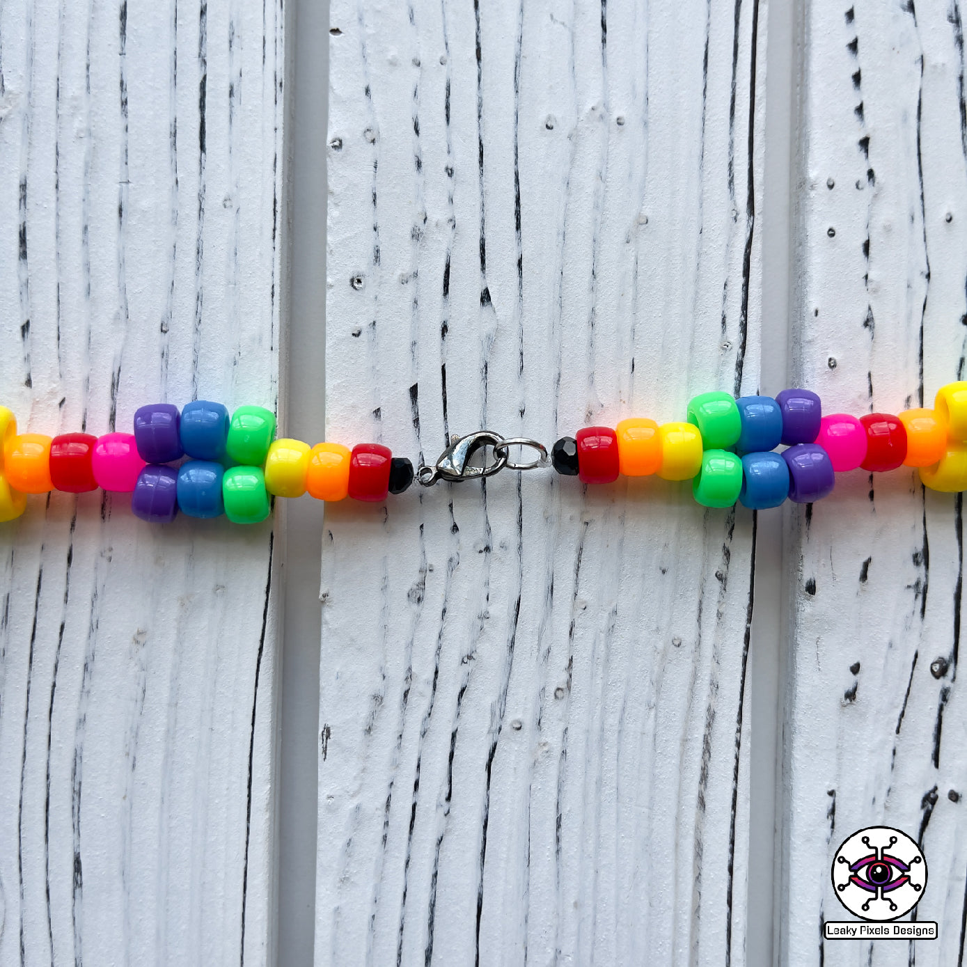 Rainbow unicorn perler necklace by leaky pixels. white unicorn with rainbow colored hair.