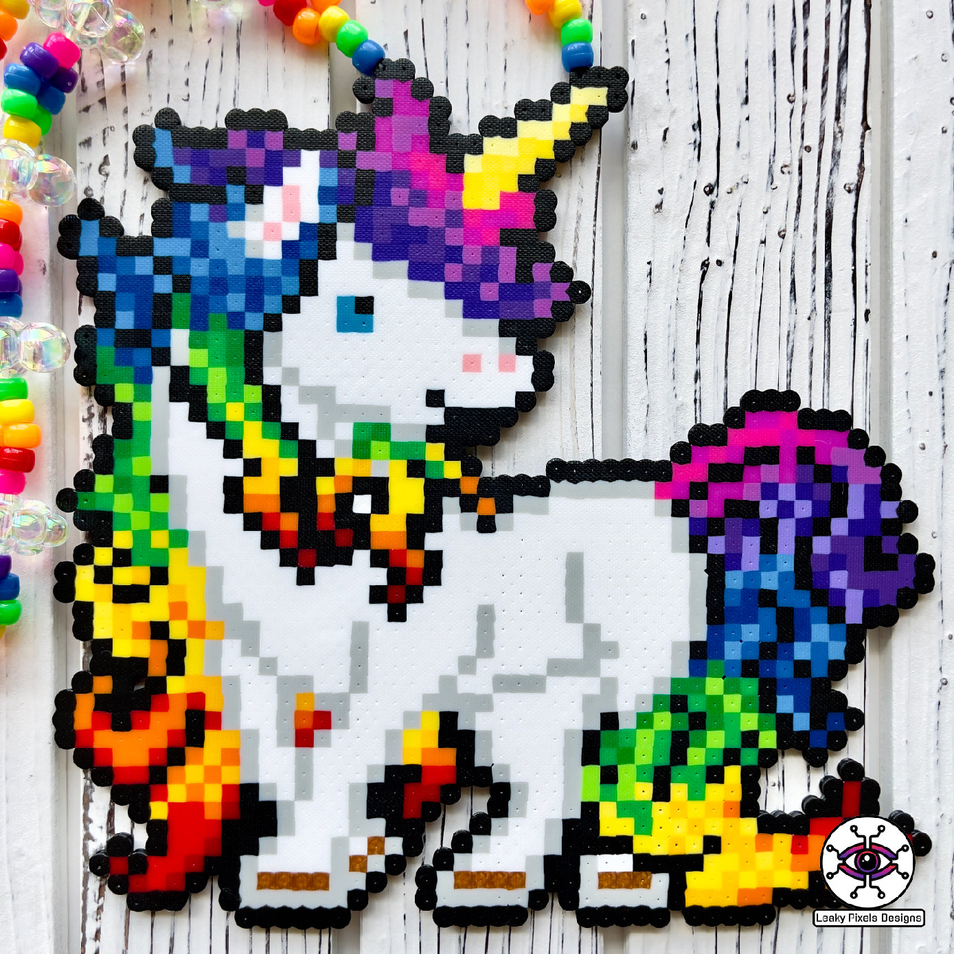 Rainbow unicorn perler necklace by leaky pixels. white unicorn with rainbow colored hair.