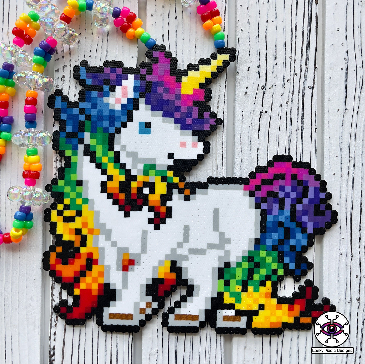 Rainbow unicorn perler necklace by leaky pixels. white unicorn with rainbow colored hair.