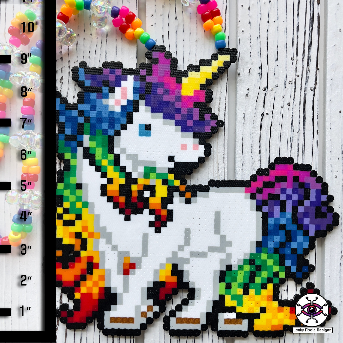 Rainbow unicorn perler necklace by leaky pixels. white unicorn with rainbow colored hair.