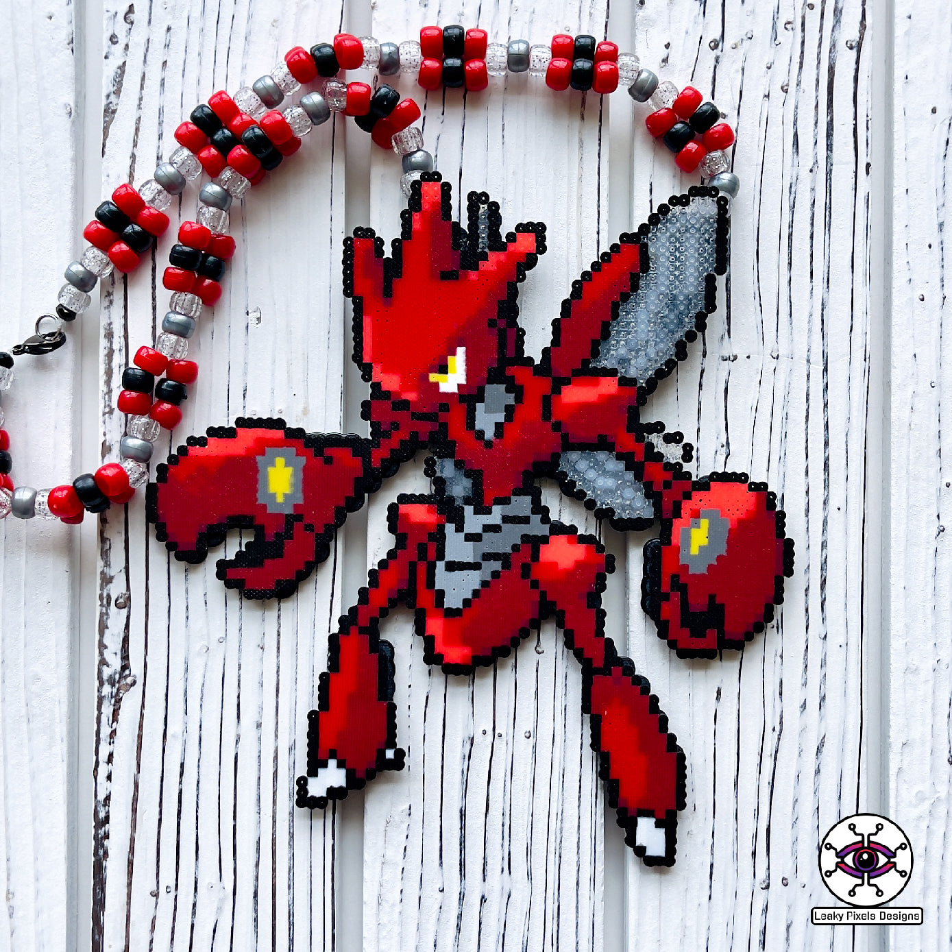 Red Scizor pokemon bug perler necklace with two wings and large pincers. Necklace is made with red, black, silver and clear glitter pony beads.