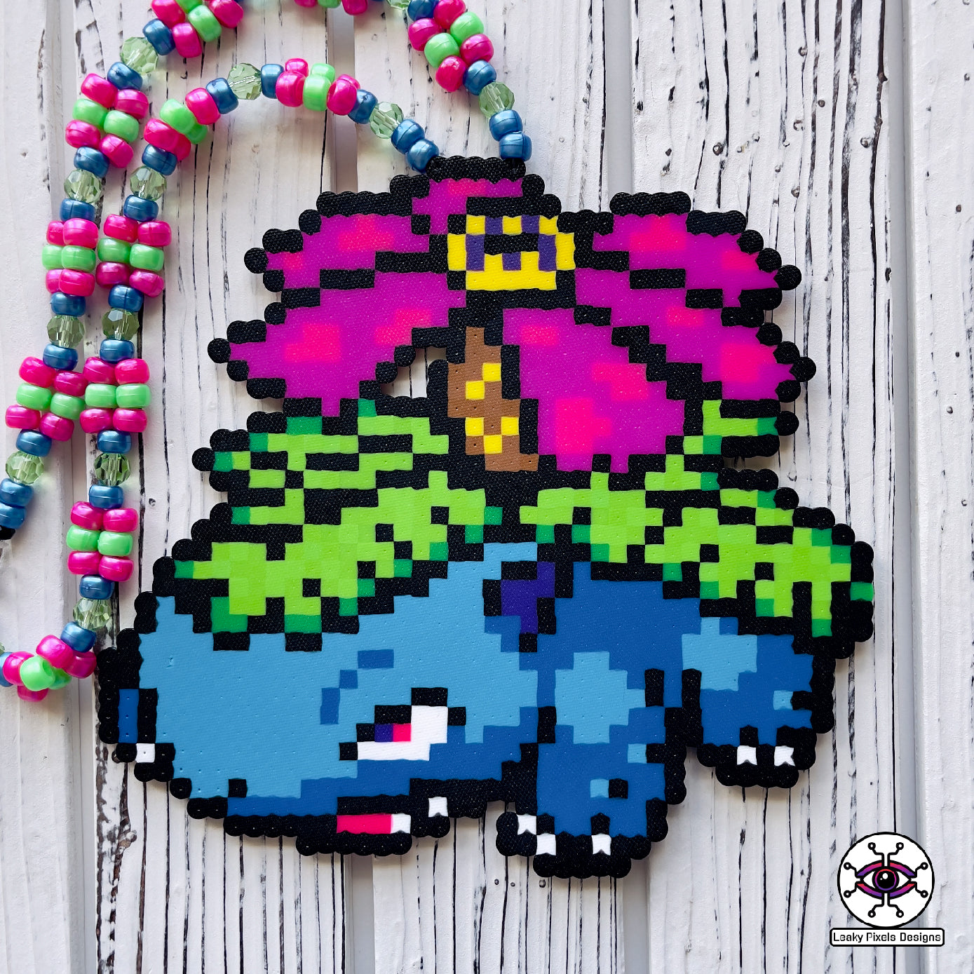 Venusaur perler necklace with rainbow flower on back pokemon. blue pokemon with a rainbow flower and green leaves. Rainbow pony beaded necklace.